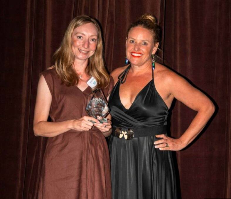 Hawkesbury Gazette journalist Sarah Falson (left) receives her award from ACM Head of Content and Head of Travel, Kate Cox.
