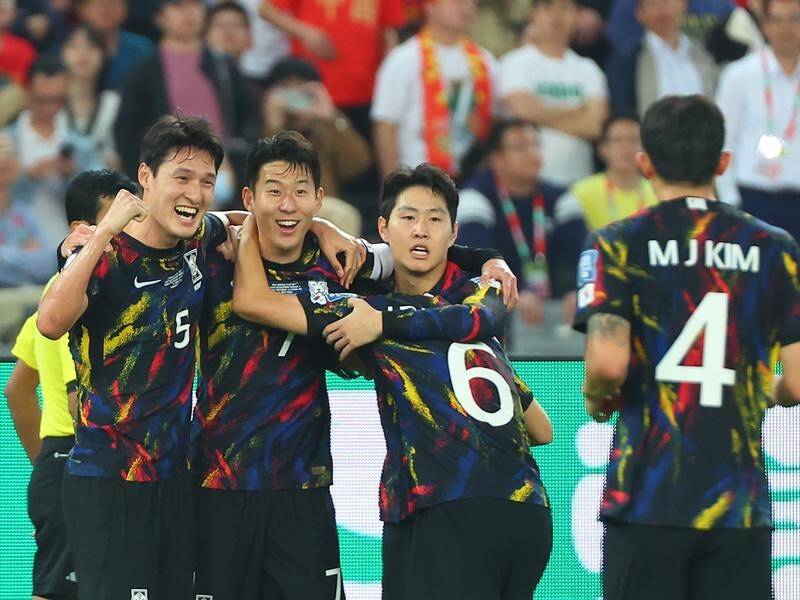 Son Heung-min (2nd left) celebrates with teammates after scoring South Korea's second against China. (EPA PHOTO)