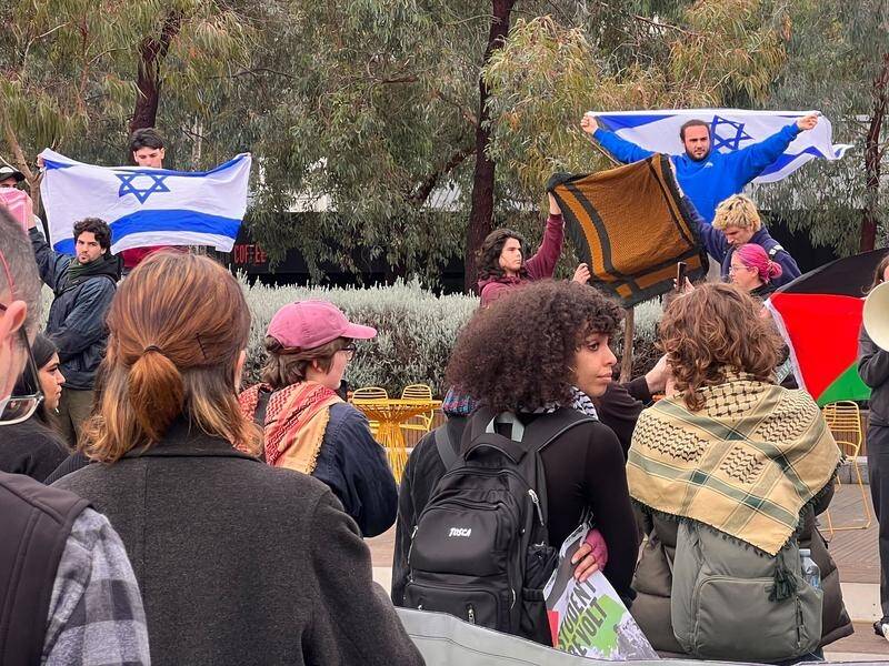 Students have brandished Israel flags at a pro-Palestine protest at Monash University in Melbourne. (Holly Hales/AAP PHOTOS)